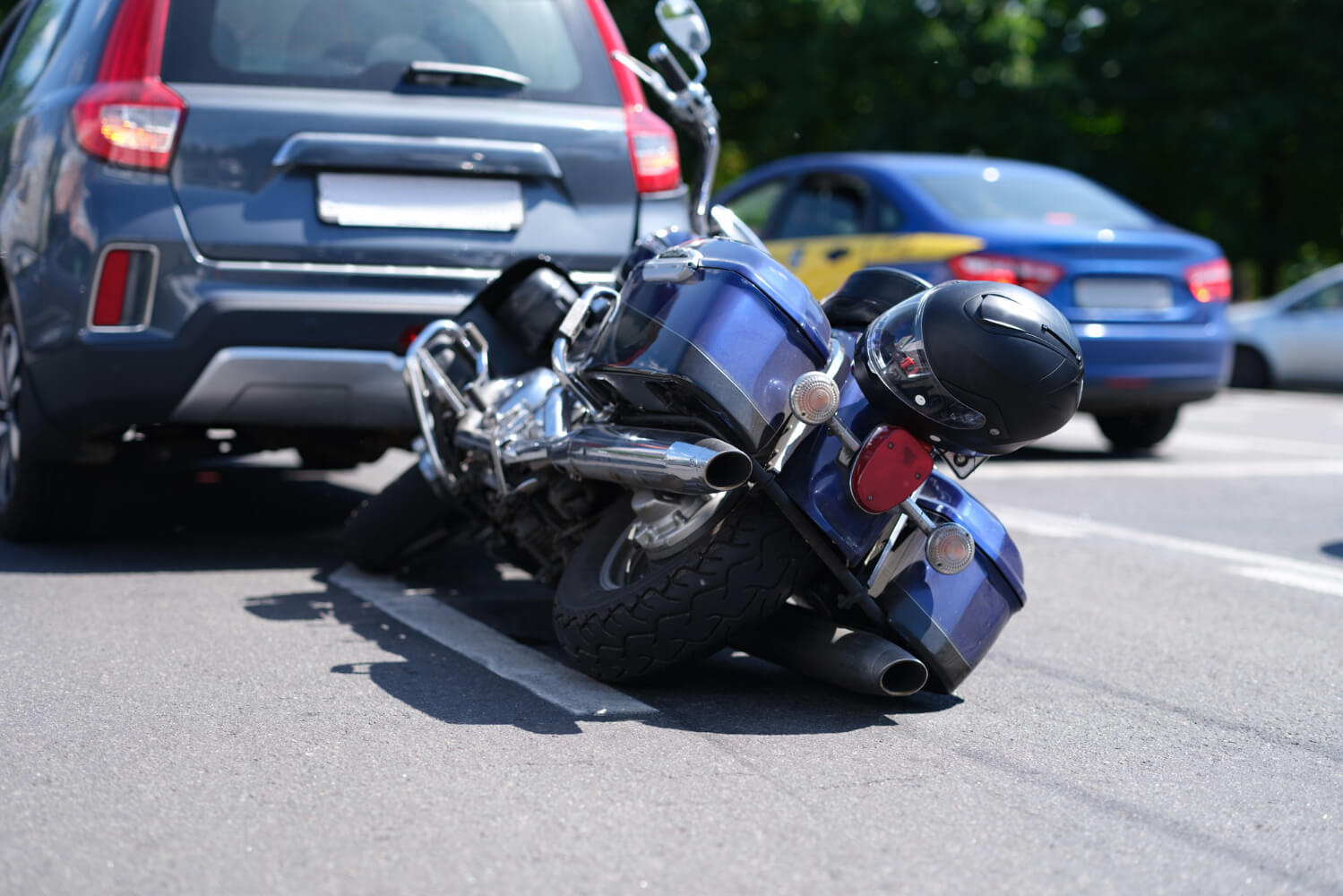 blue motorcycle lying road near car closeup - Motorcycle Accident